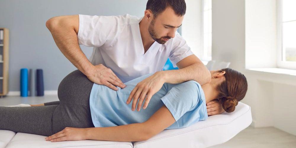 A woman is getting a chiropractic adjustment.