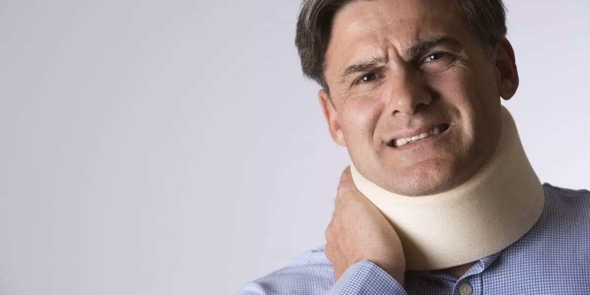 A man in a neck brace is suffering from whiplash injuries.