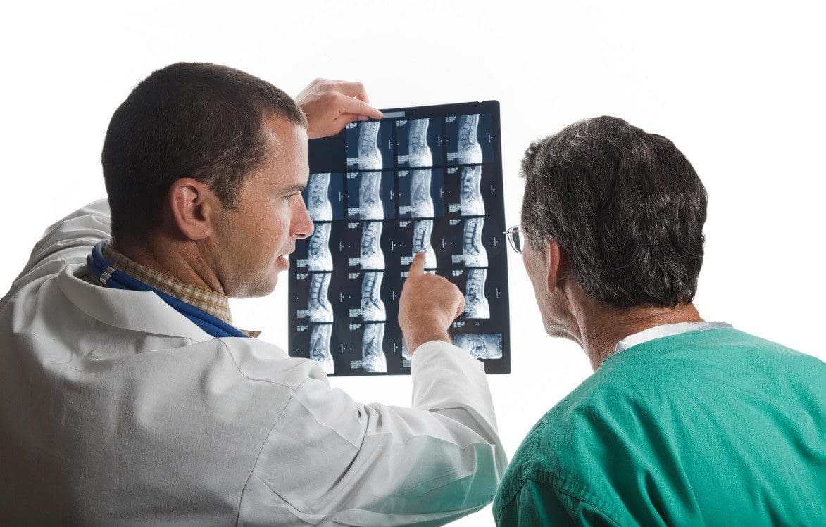 A chiropractor examines X-Rays