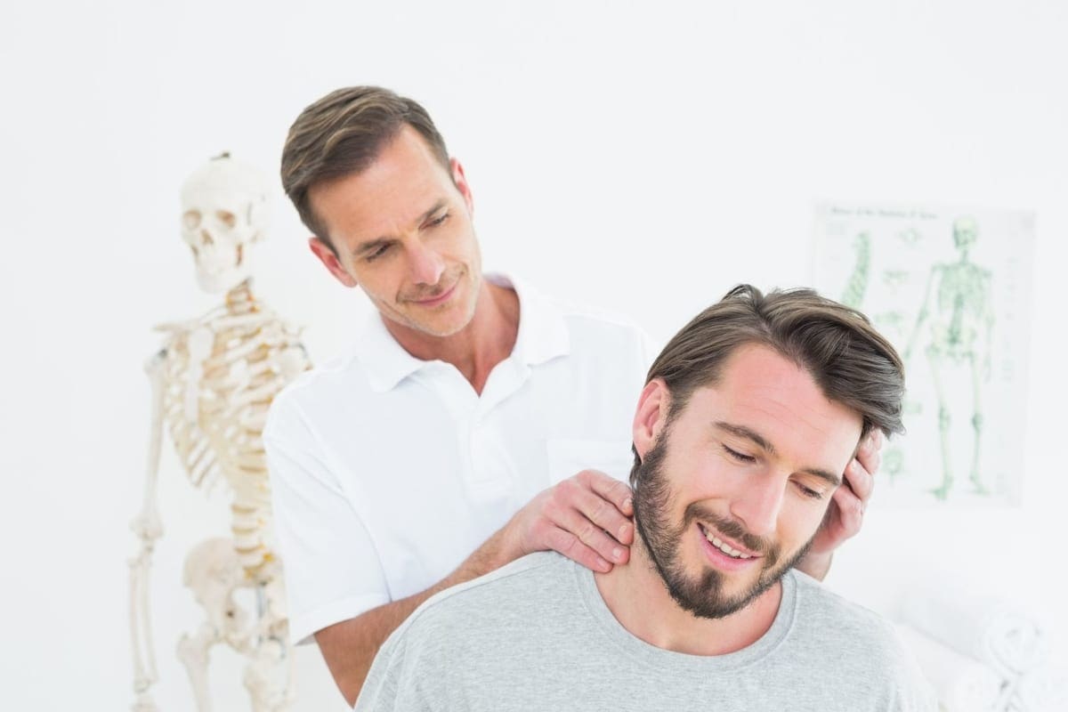 A man experiences pain relief during a neck adjustment.