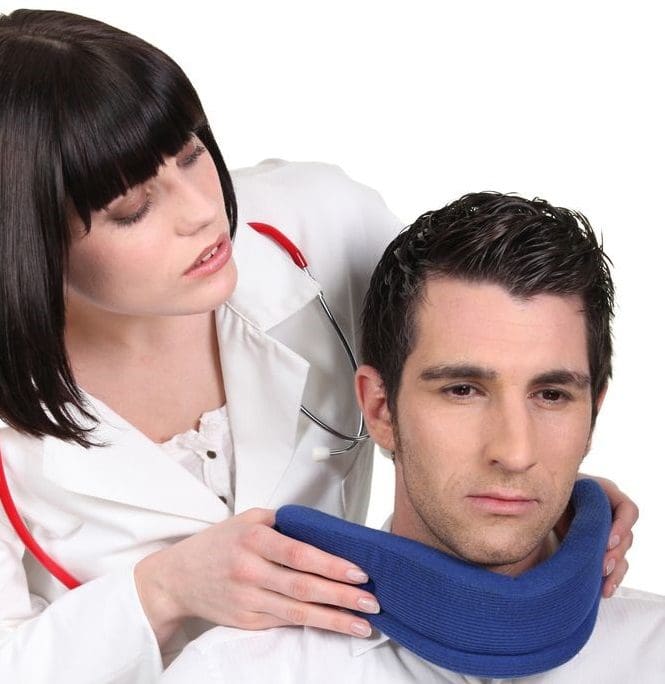 A doctor removes a neck brace from a man for further examination.