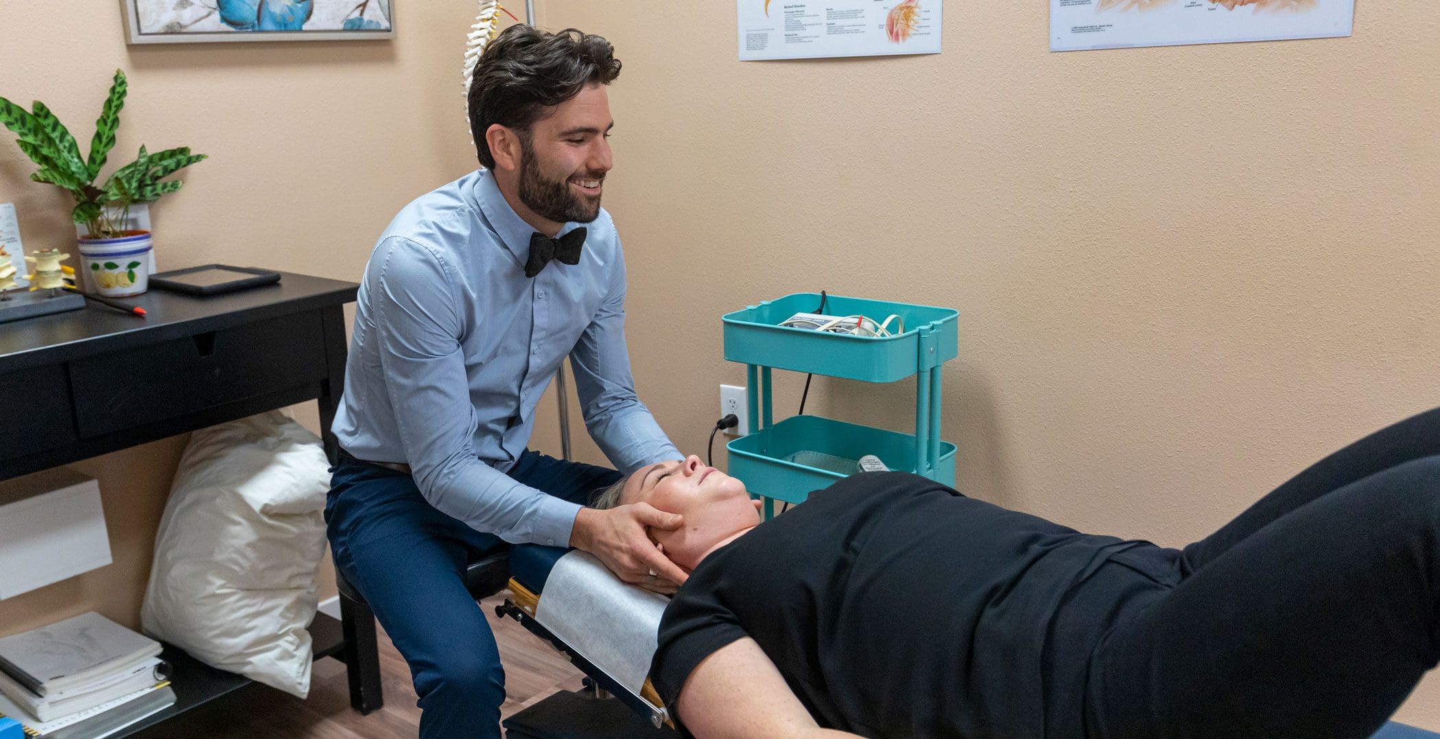 Tigard Chiropractor administers a neck adjustment to treat whiplash pain.