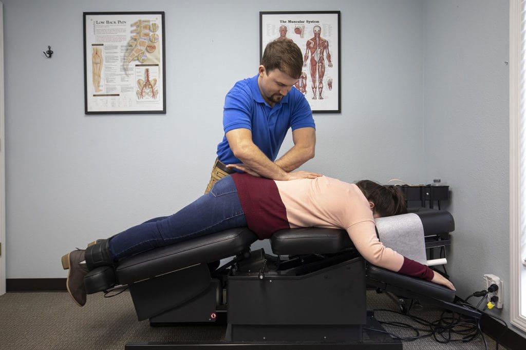 A chiropractor in Salem administers a back adjustment to alleviate pain.