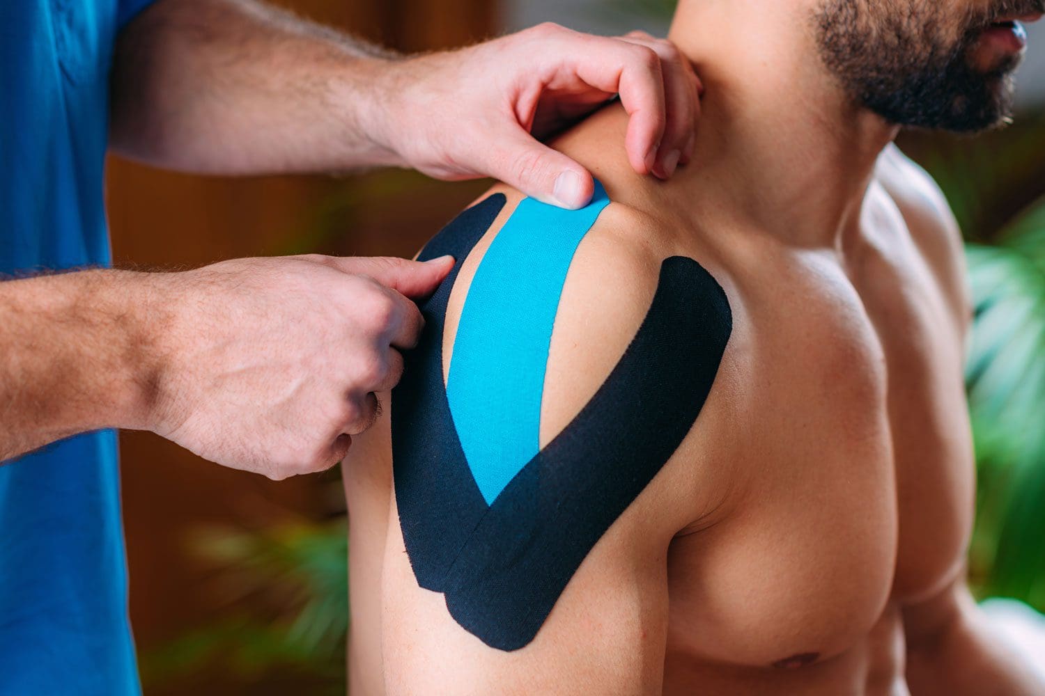 Gresham chiropractor treats a man's sports injury with Kinesio Tape.