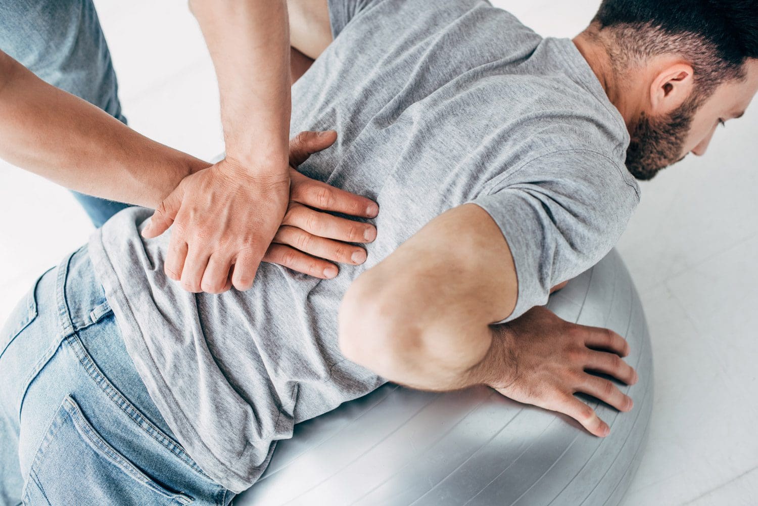 A Beaverton Chiropractor administers an adjustment to alleviate a man's back pain.