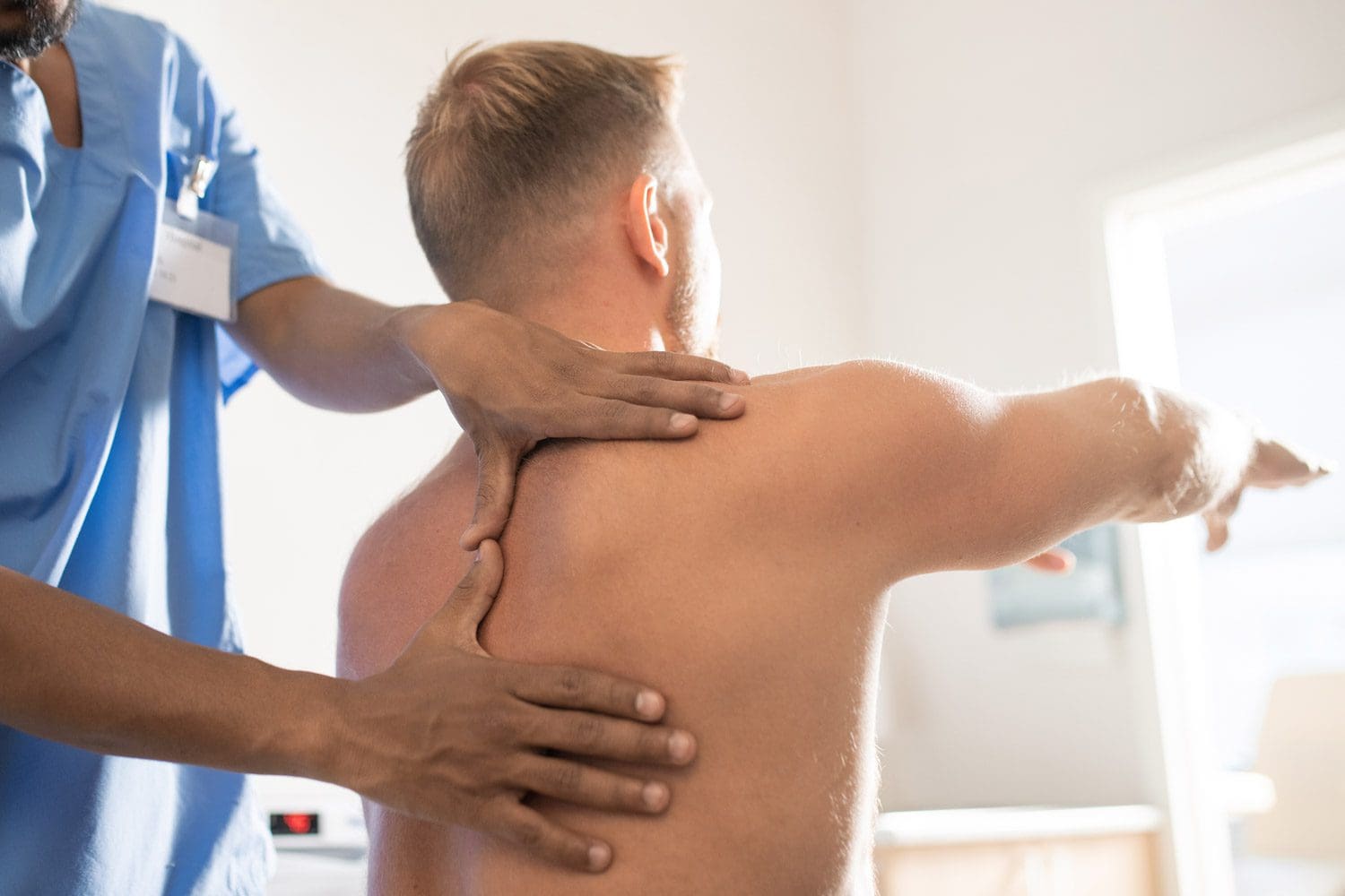 A chiropractor treats a man to restore range of motion to his back in Beaverton Oregon.