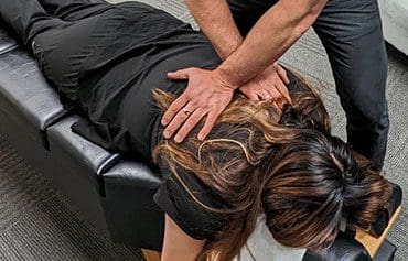 a woman getting spinal manipulation treatment.