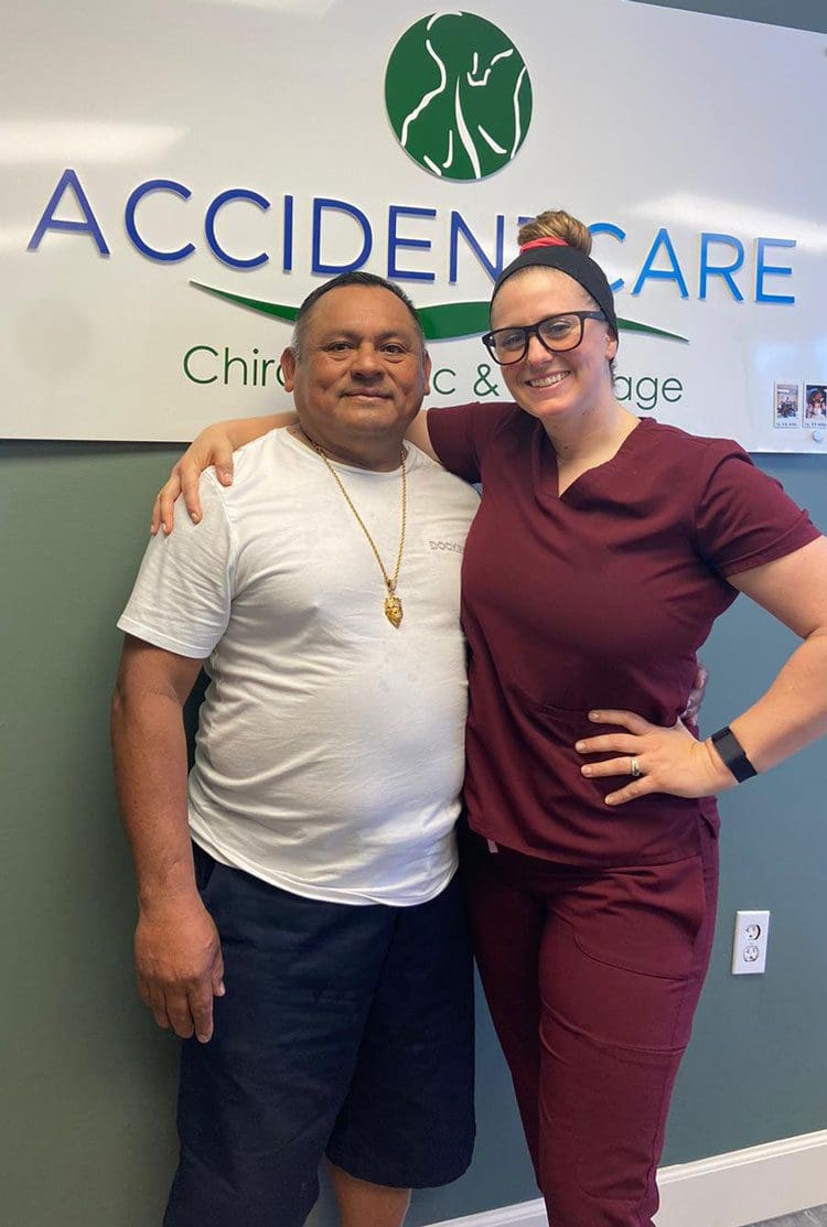 Dr. Austin Bell, D.C. with a happy male Hispanic patient after recovering from an auto injury.