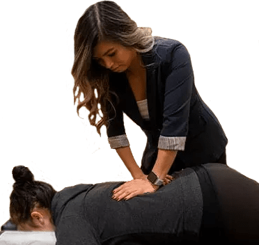 Dr. Linda Nguyen, D.C. adjusting a female patient's lower back.