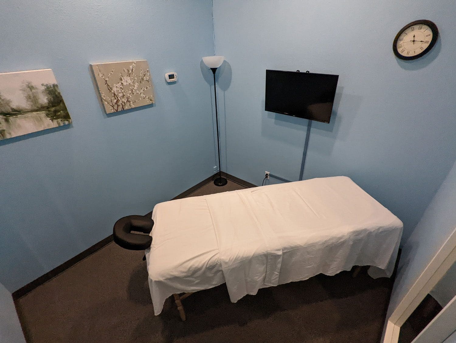 McMinnville massage therapy room with light blue walls and a massage table.