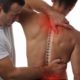 A man is getting back pain relief from chiropractic treatment.