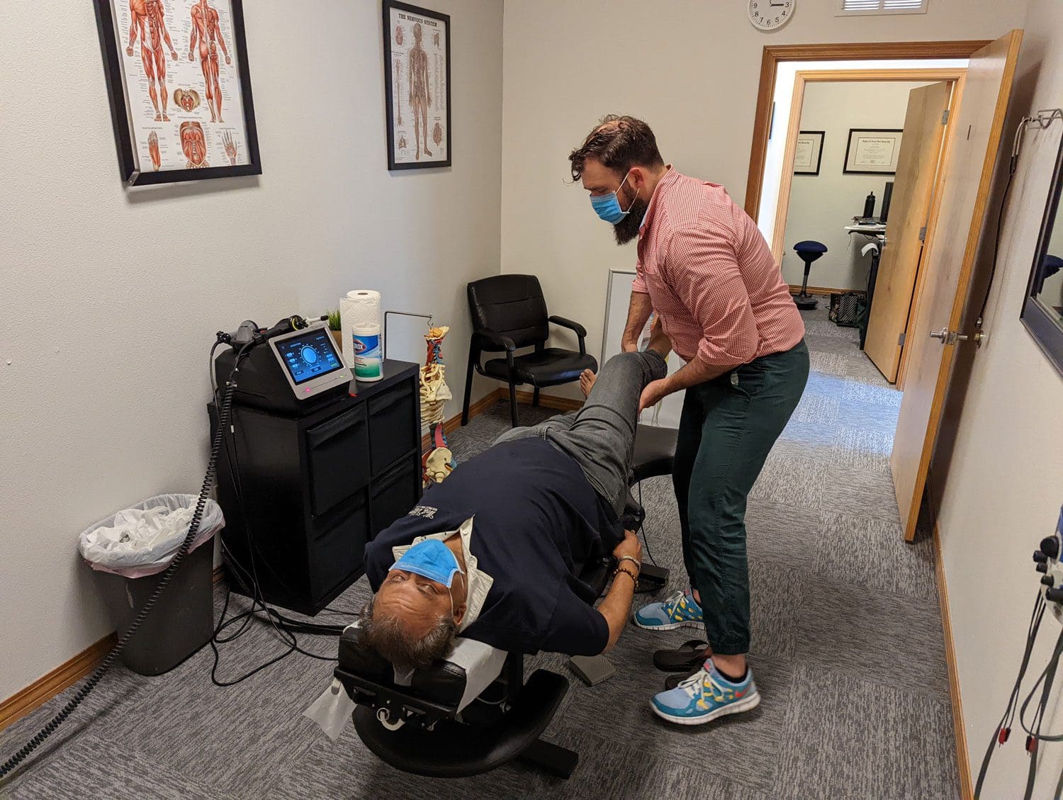 A chiropractor is administering a chiropractic adjustment at the Beaverton clinic.