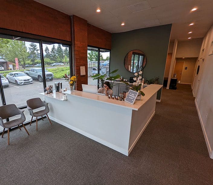 Clackamas Chiropractor Clinic front desk and reception area with large windows.