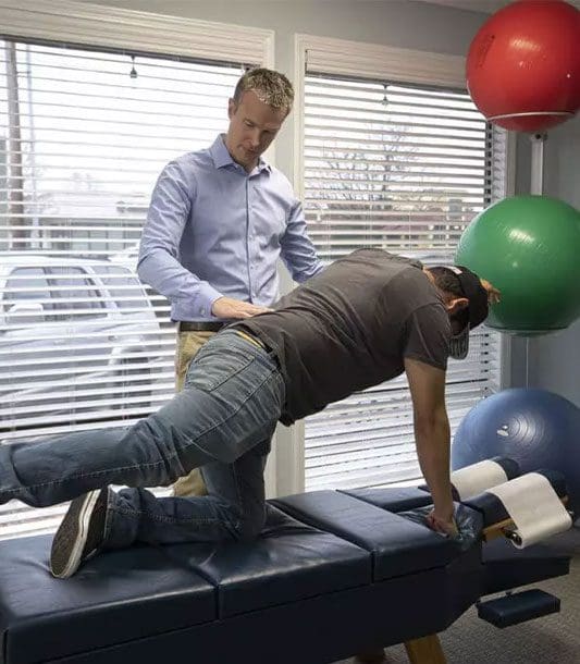 A chiropractor is helping a patient recover through physical therapy treatment at the Salem clinic.