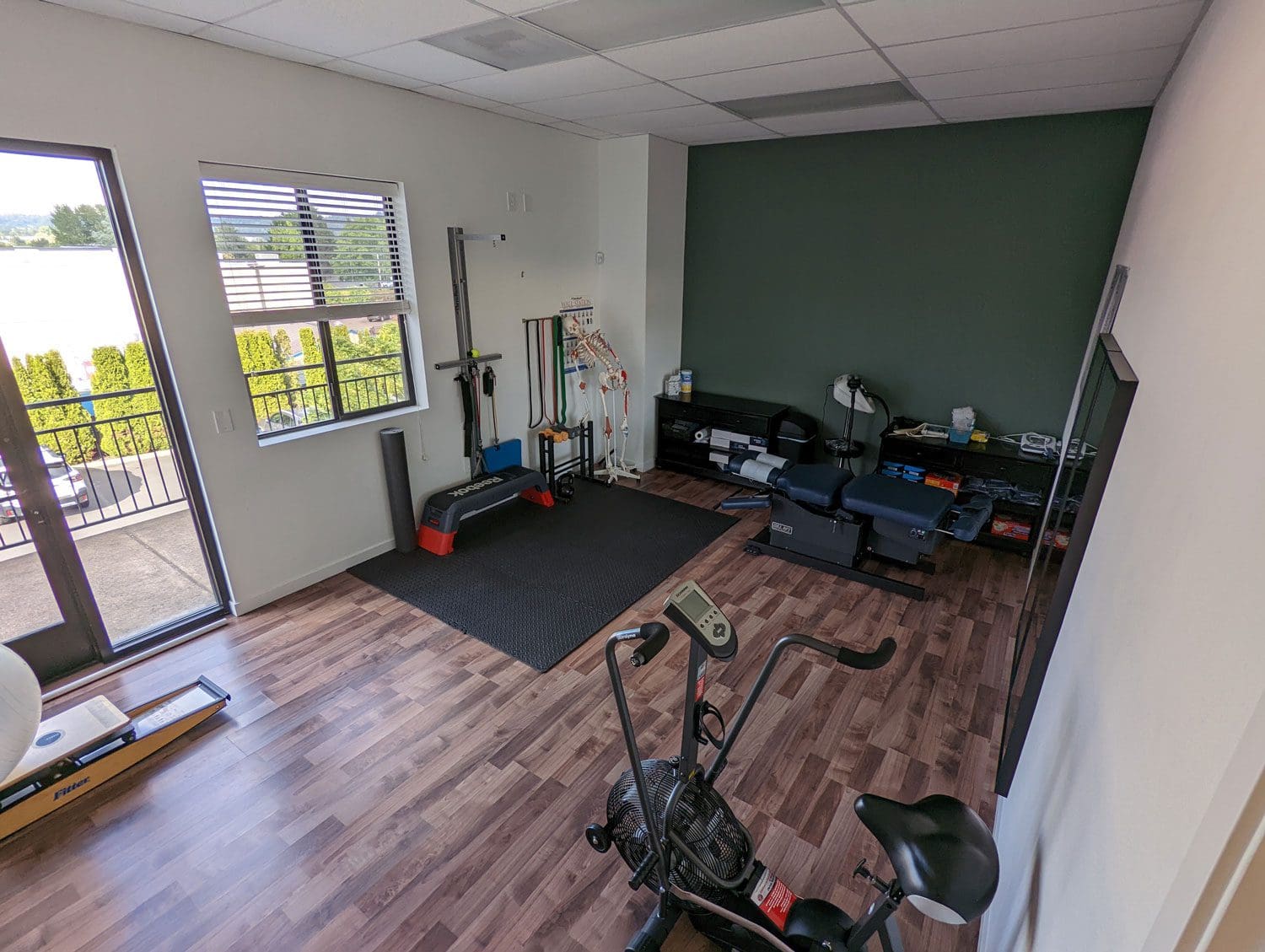 Tigard Chiropractor rehabilitation room with exercise and physical therapy equipment.
