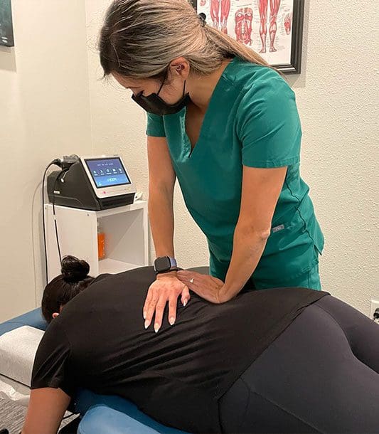 A chiropractor is administering a chiropractic adjustment.