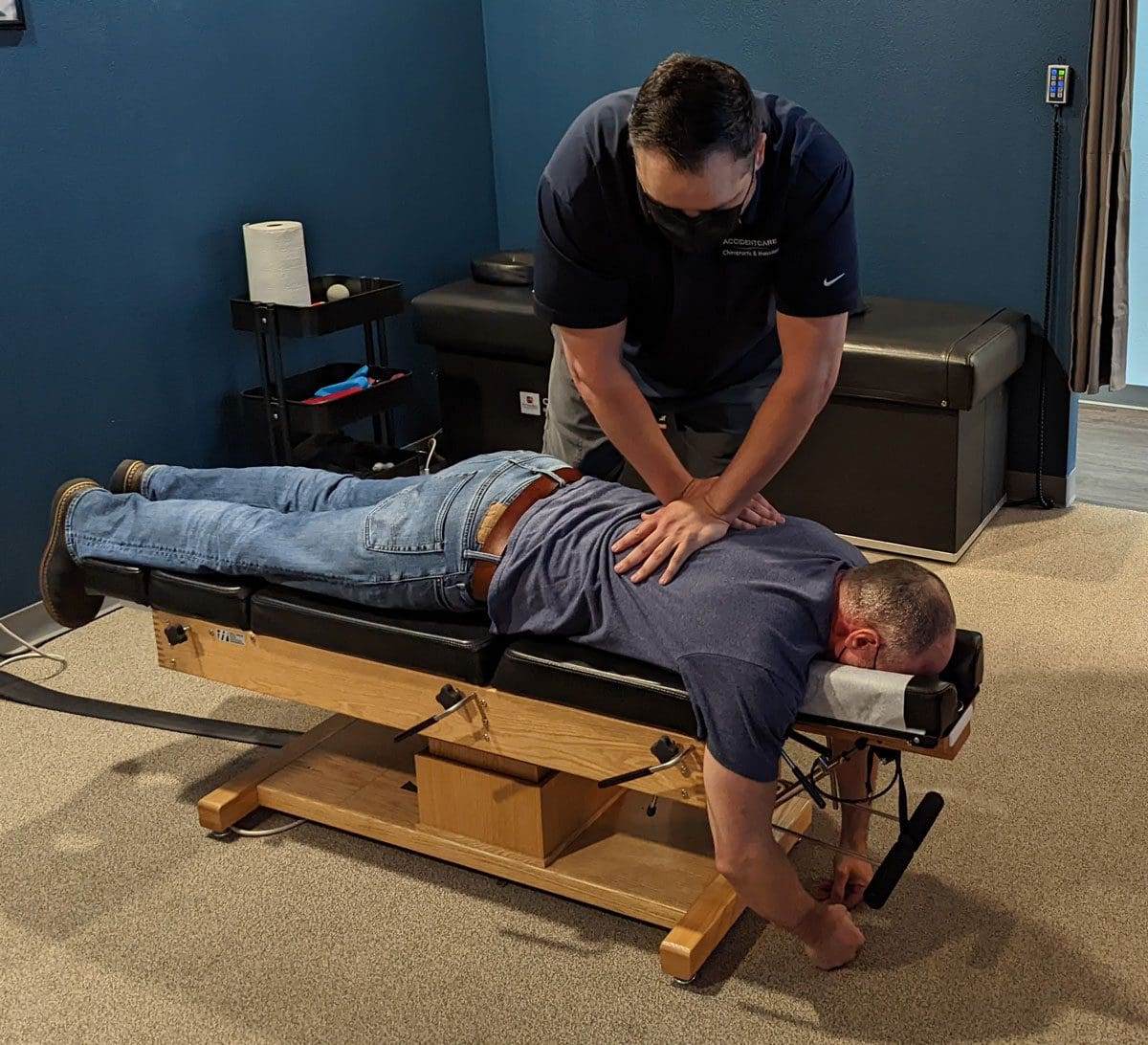 A man is receiving a chiropractic adjustment at Accident Care Chiropractic in Vancouver.