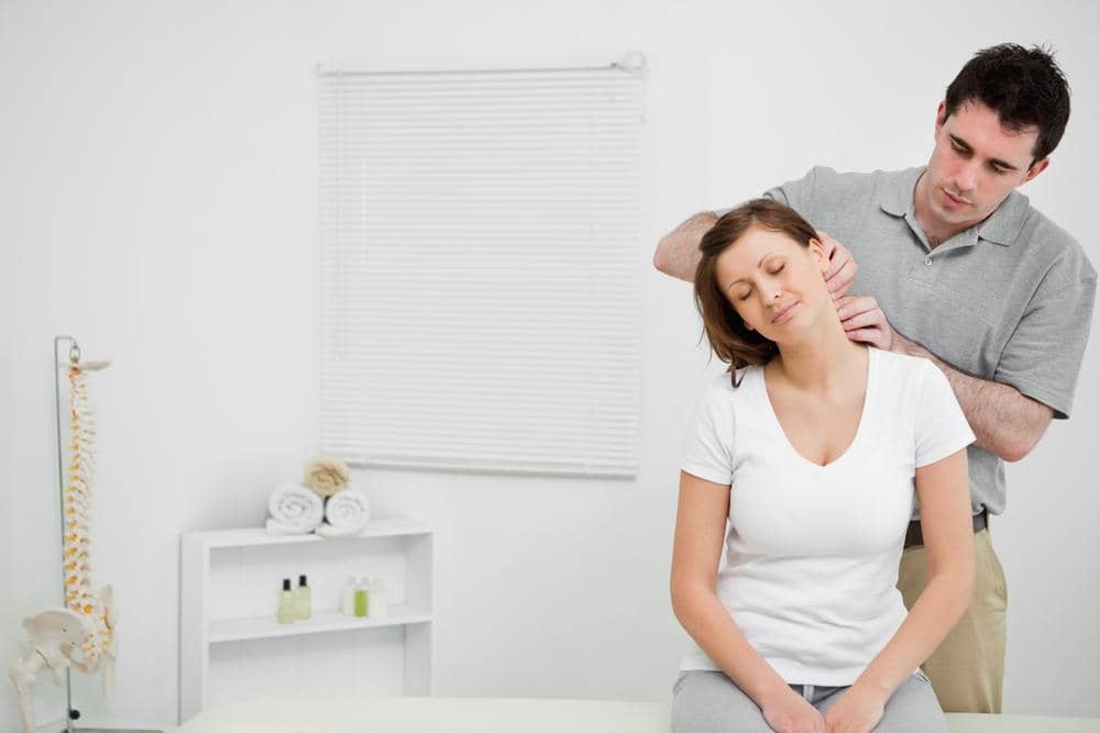 A woman is receiving chiropractic care for a whiplash injury.