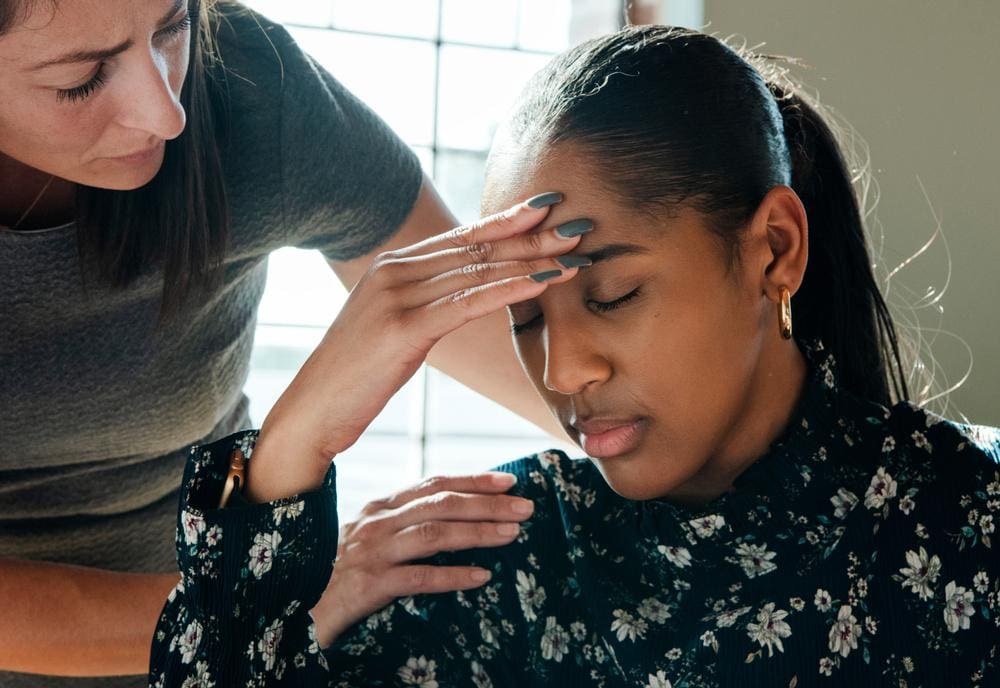 A woman consults a chiropractor about her debilitating chronic headaches.