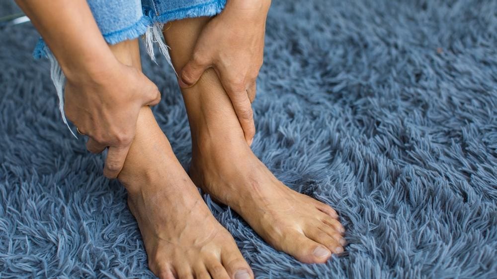 A woman is struggling with poor circulation in her feet.