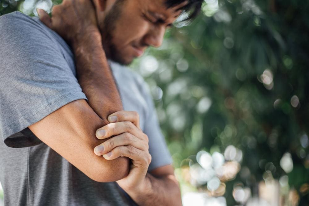 A man is suffering from debilitating elbow pain.