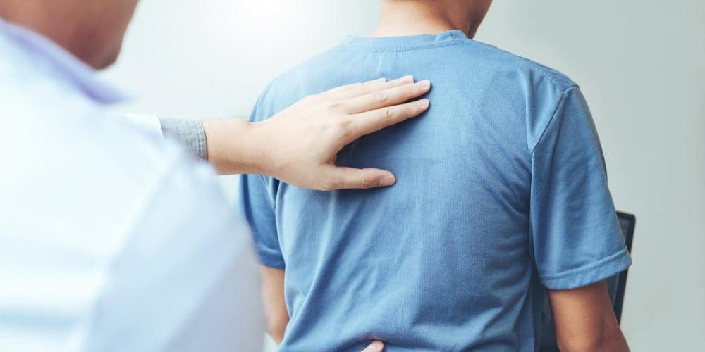 A chiropractor is treating a man for a personal injury.