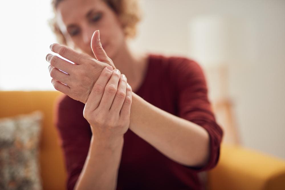 A woman is experiencing nerve pain from nerve damage in her wrist and hand. 