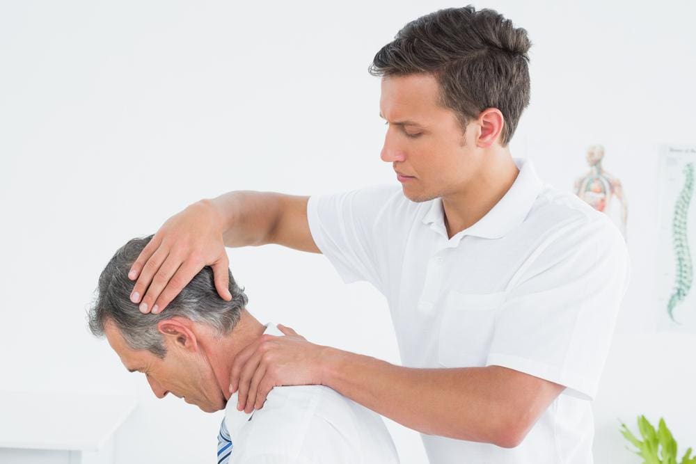 A chiropractor is treating a man for tinnitus. 