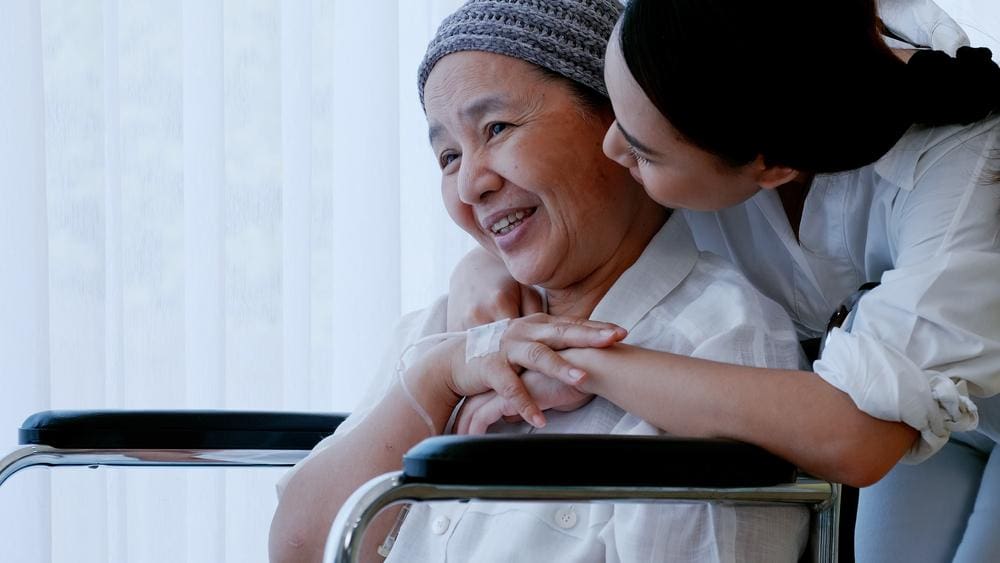 A woman is visiting her mother, who is going through chemotherapy. 
