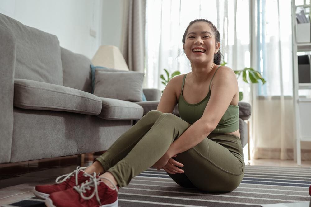 A woman is happy after recovering from a hamstring injury. 