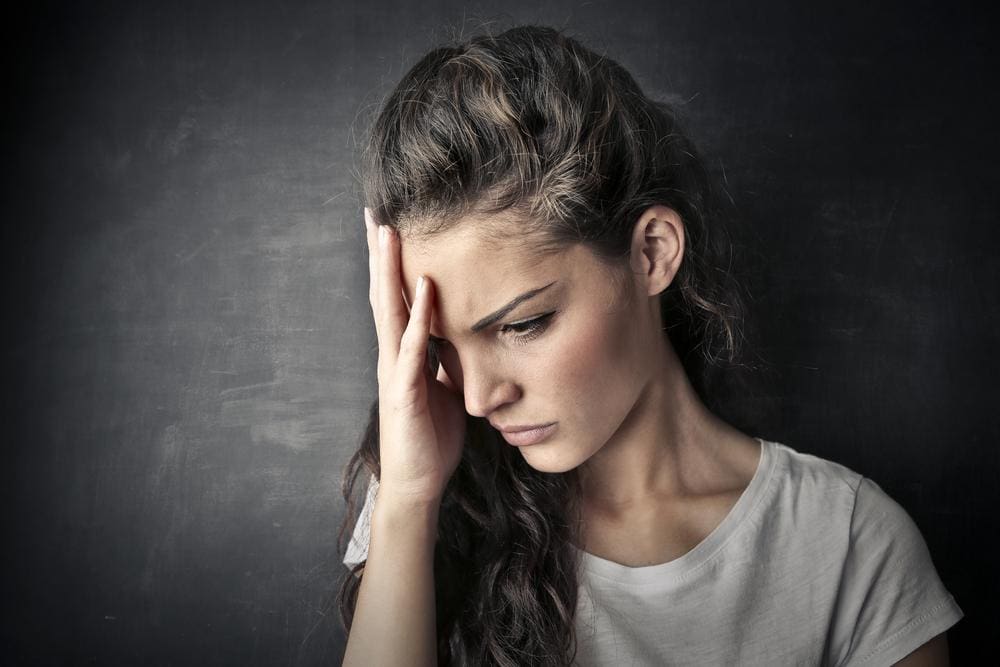 A woman is suffering from migraine headaches.