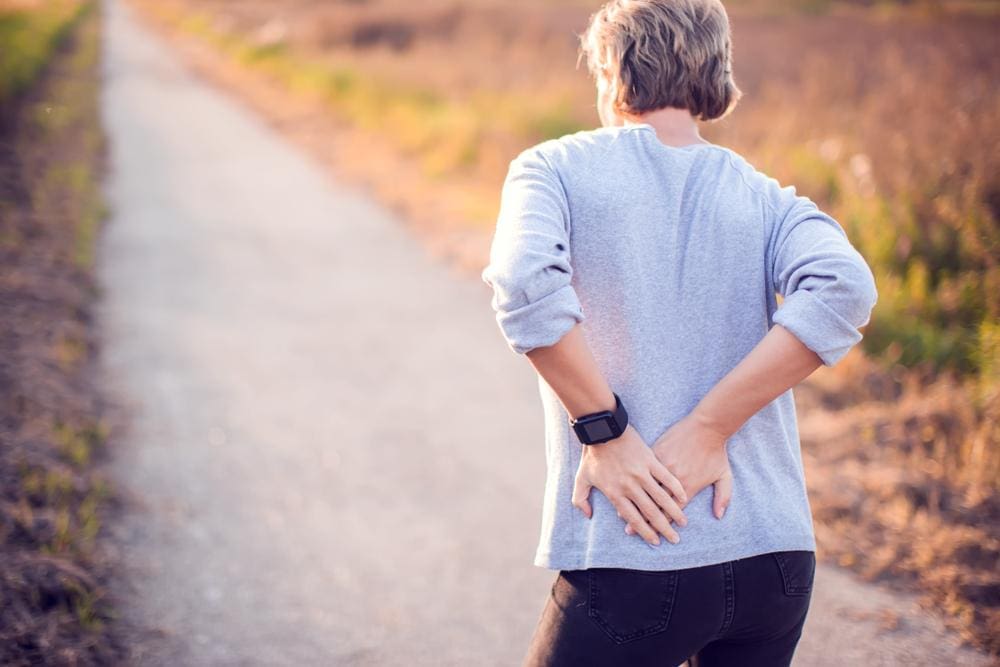 A woman is struggling to walk because of hip flexor pain.