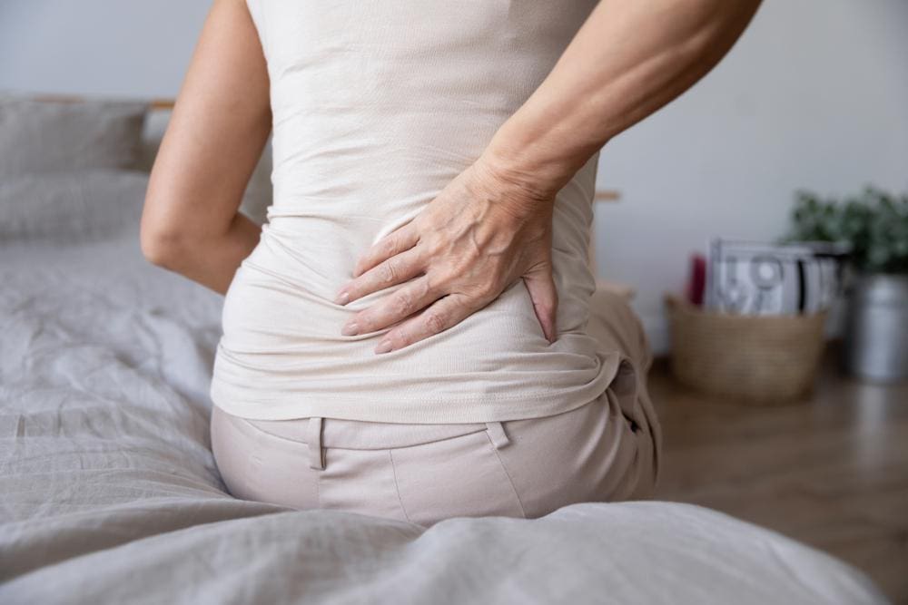 A woman is suffering from sciatica pain. 