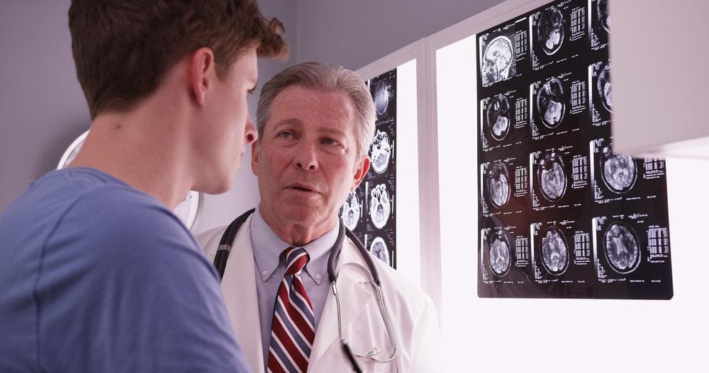 A man is consulting a doctor for a concussion diagnosis. 