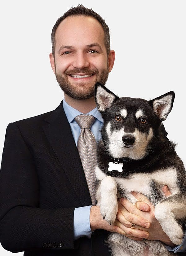Dr. Eric Neumann, D.C. - Chiropractor Tigard holding his dog Ruben.