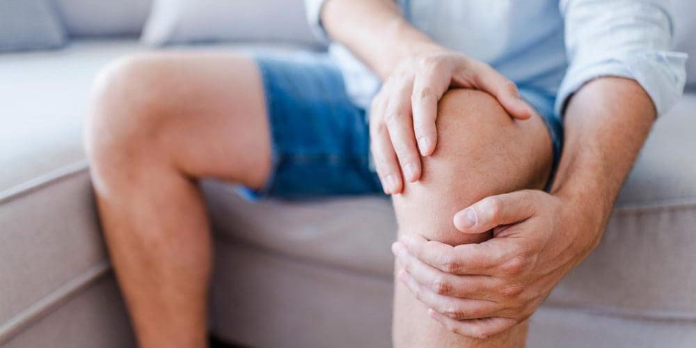 A man is suffering from arthritis pain in his knee.