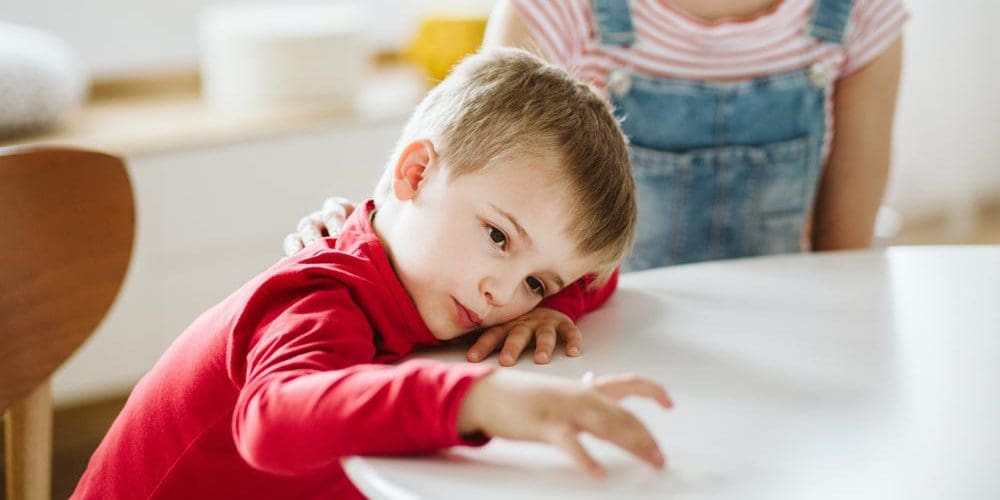 A young child is ignoring his caretaker because he struggles ADHD.