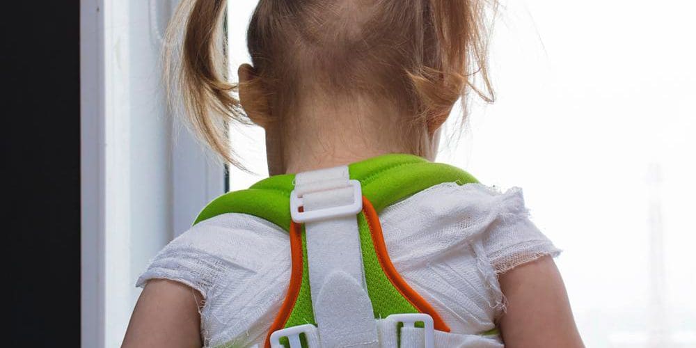A child is wearing a back brace.