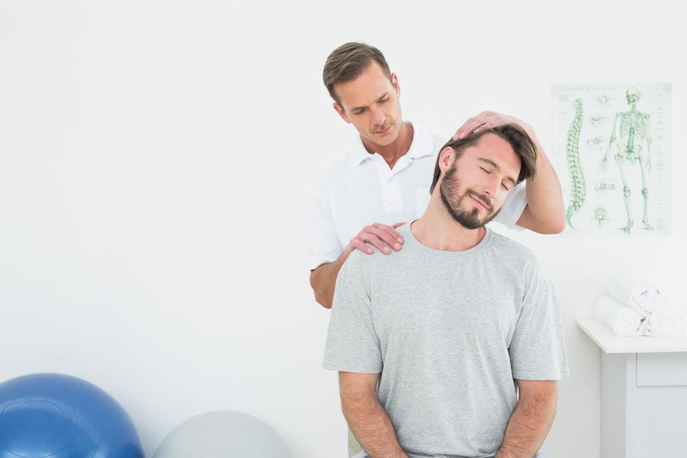 A chiropractor is administering adjustments to relieve pain. 