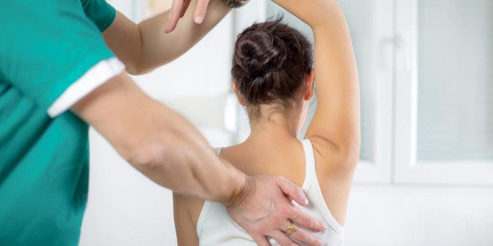 A chiropractor is administering adjustments for pain relief.