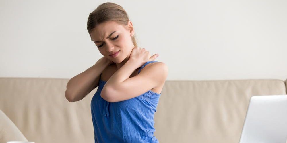 A woman is experiencing pain from cervical dystonia.