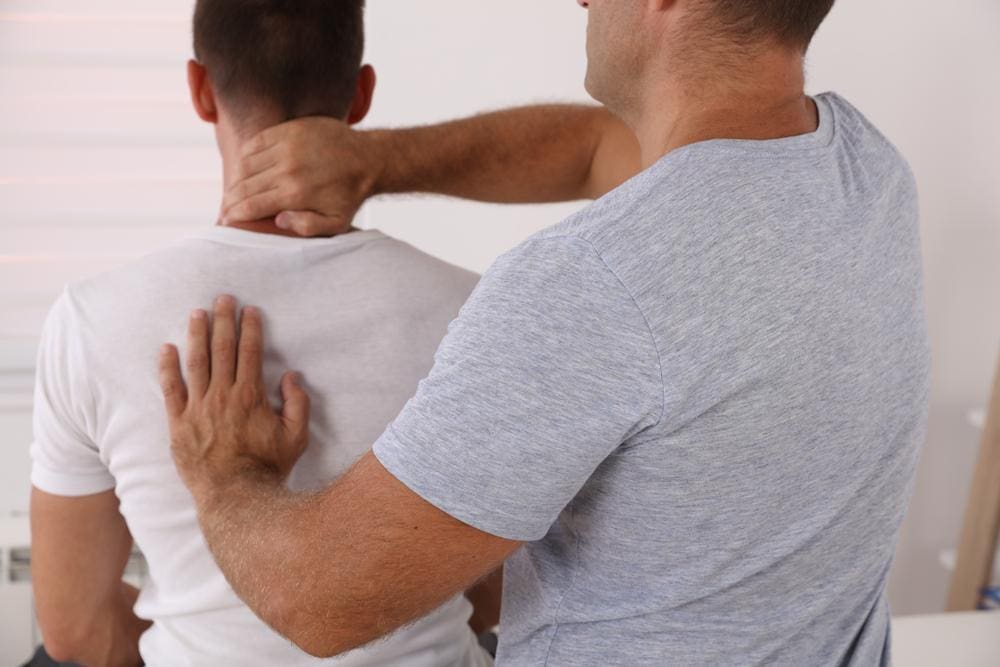 A chiropractor is treating an adult male patient. 