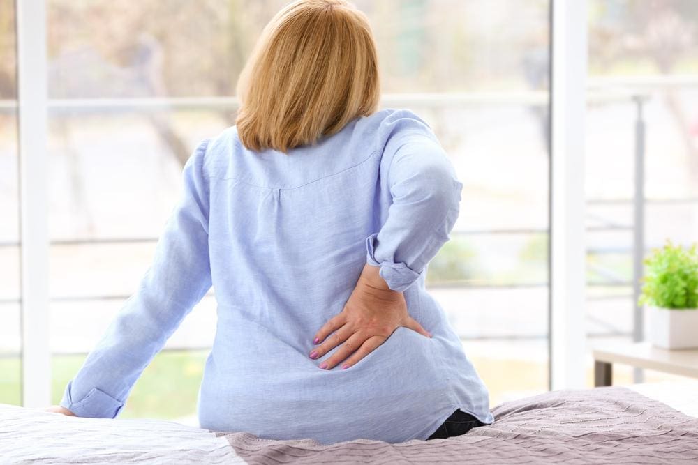 A woman is suffering from degenerative arthritis pain.