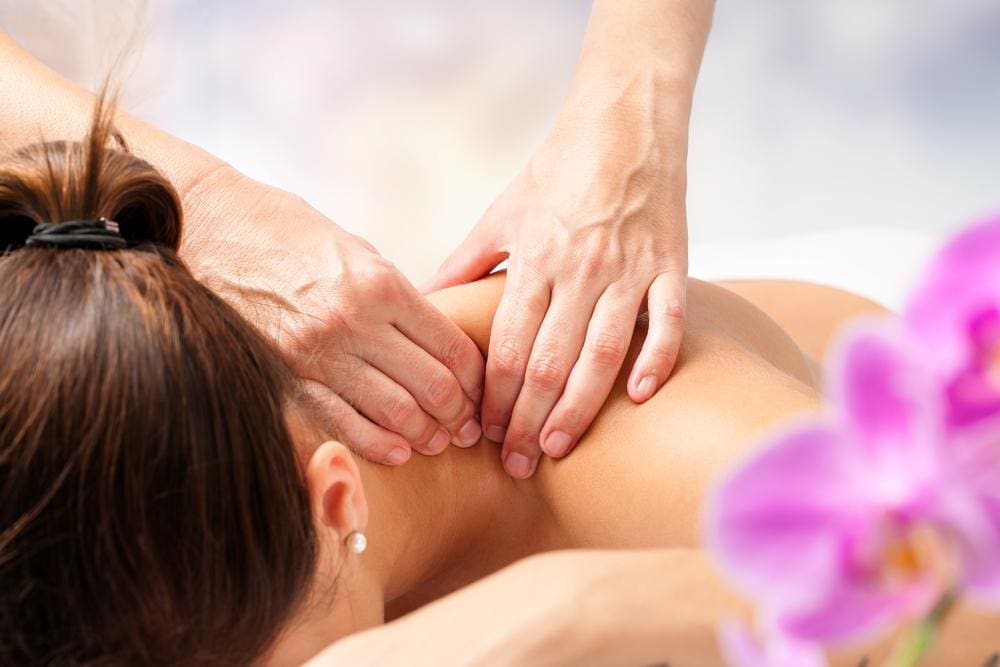 A woman is getting a therapeutic massage to ease pain from cervical radiculopathy. 