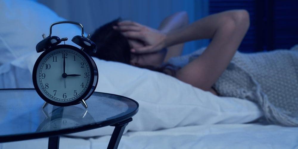 A woman is still awake in the middle of the night because she suffers from insomnia.