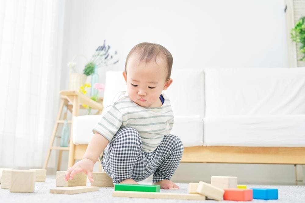 A baby is playing with blocks.