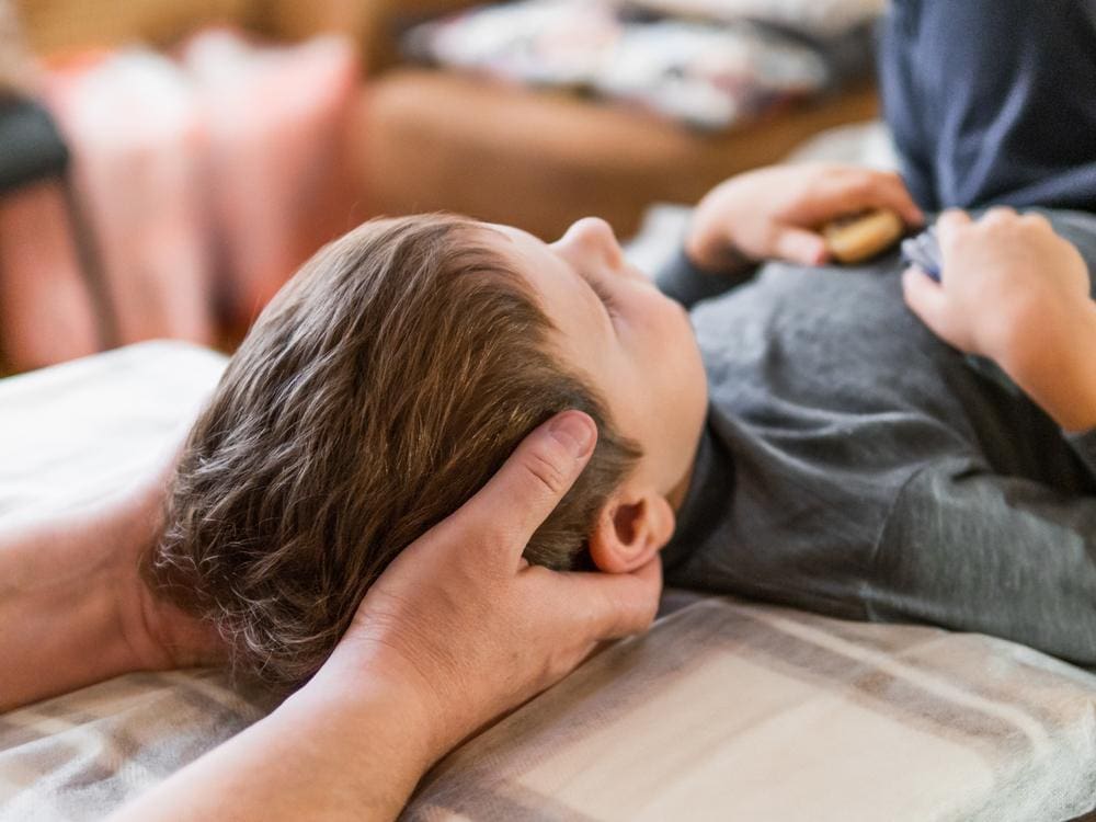 A boy is getting a chiropractic adjustment to help with behavior issues.