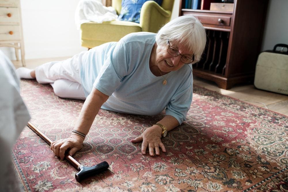 An elderly woman has fallen on the floor, and can't get up.