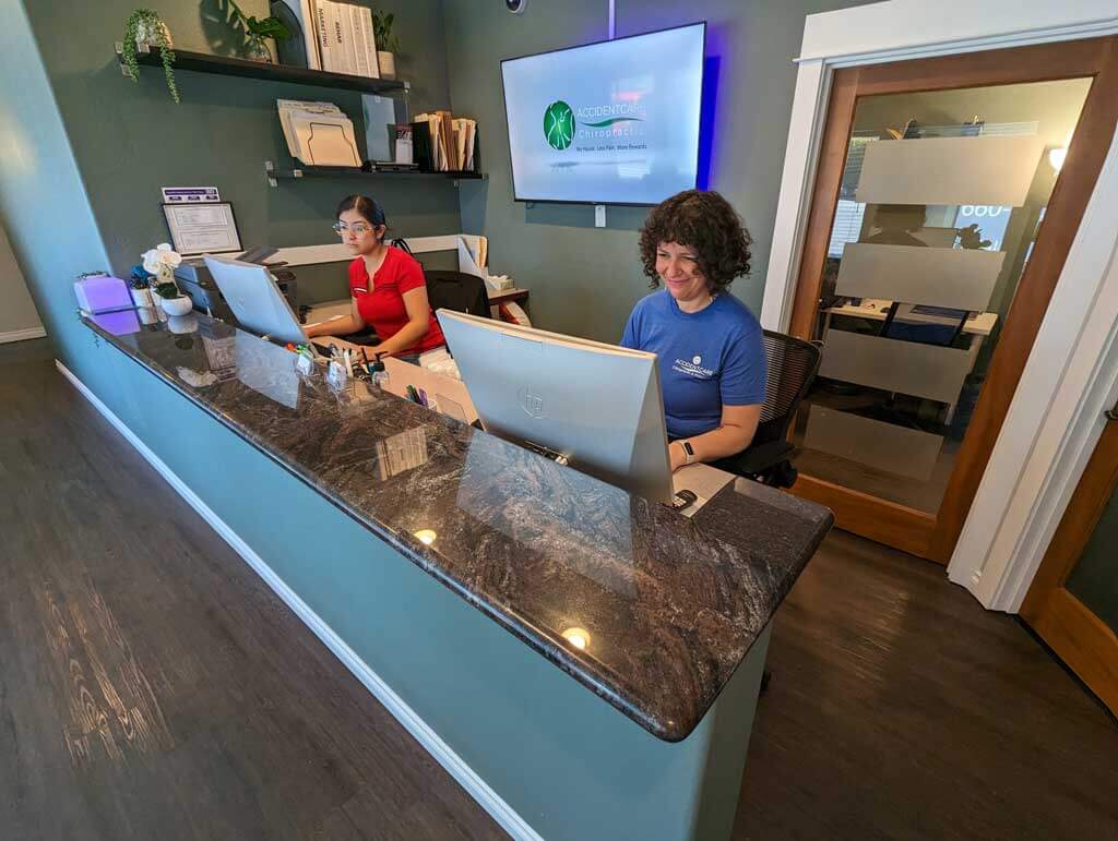 Gresham Chiropractor Clinic front desk with 2 female receptionists.