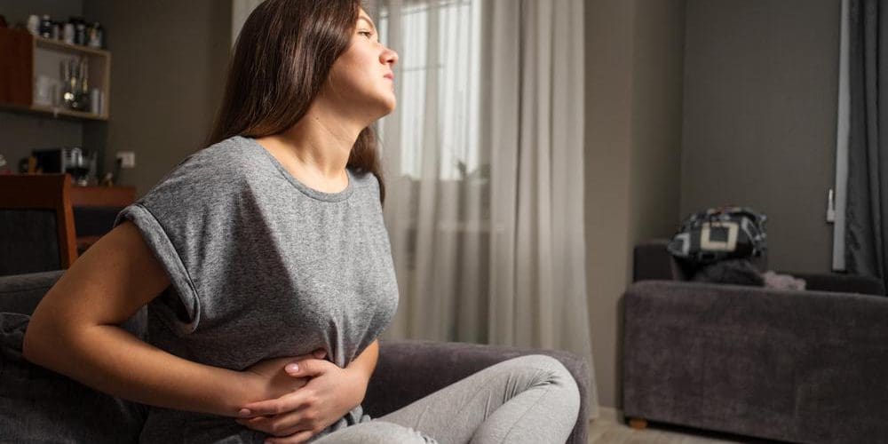 A young woman is suffering from gallbladder pain.
